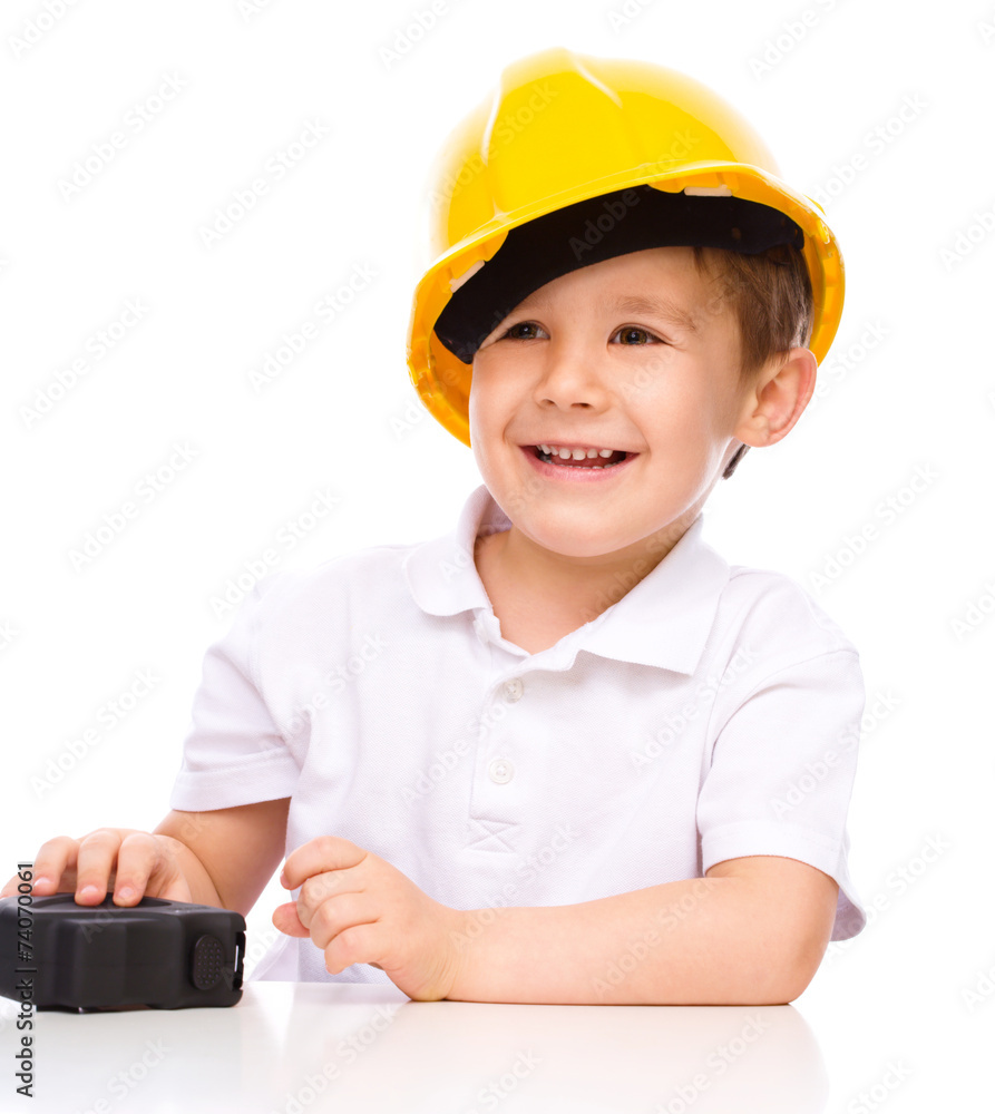 Boy as a construction worker with tape measure Boy as a construction worker with tape measure