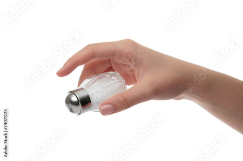 Hand holding a salt shaker