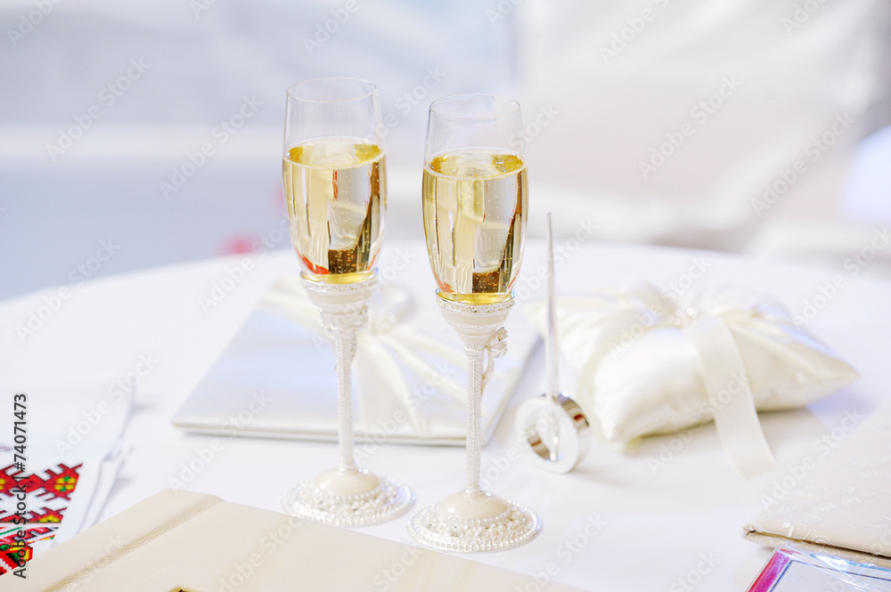 two glasses with champagne standing on the table