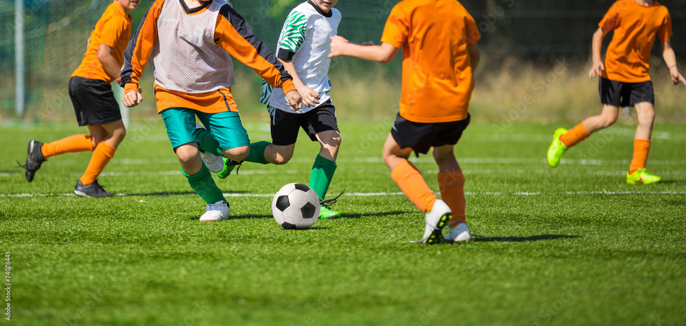 Soccer football game for children. Kids playing football soccer Soccer football game for children. Kids playing football soccer