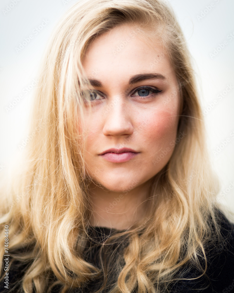 Young Blond Teenage Girl Thinking On The Beach