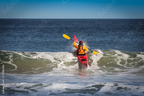 Kayak surfing on sea