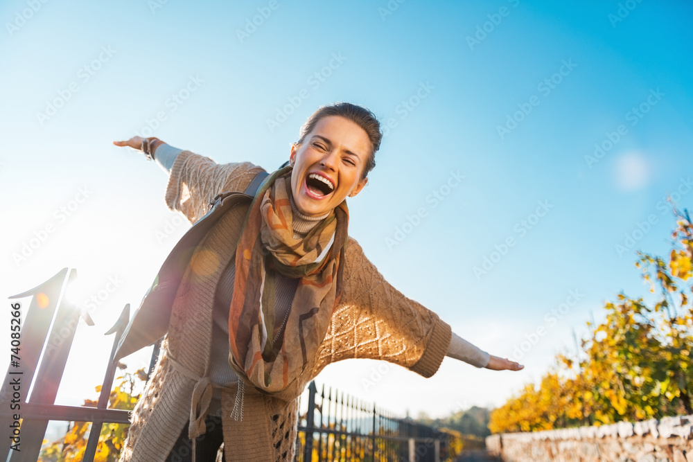 Happy young woman having fun time in autumn outdoors - obrazy, fototapety, plakaty 
