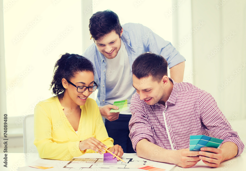 smiling interior designers working in office smiling interior designers working in office