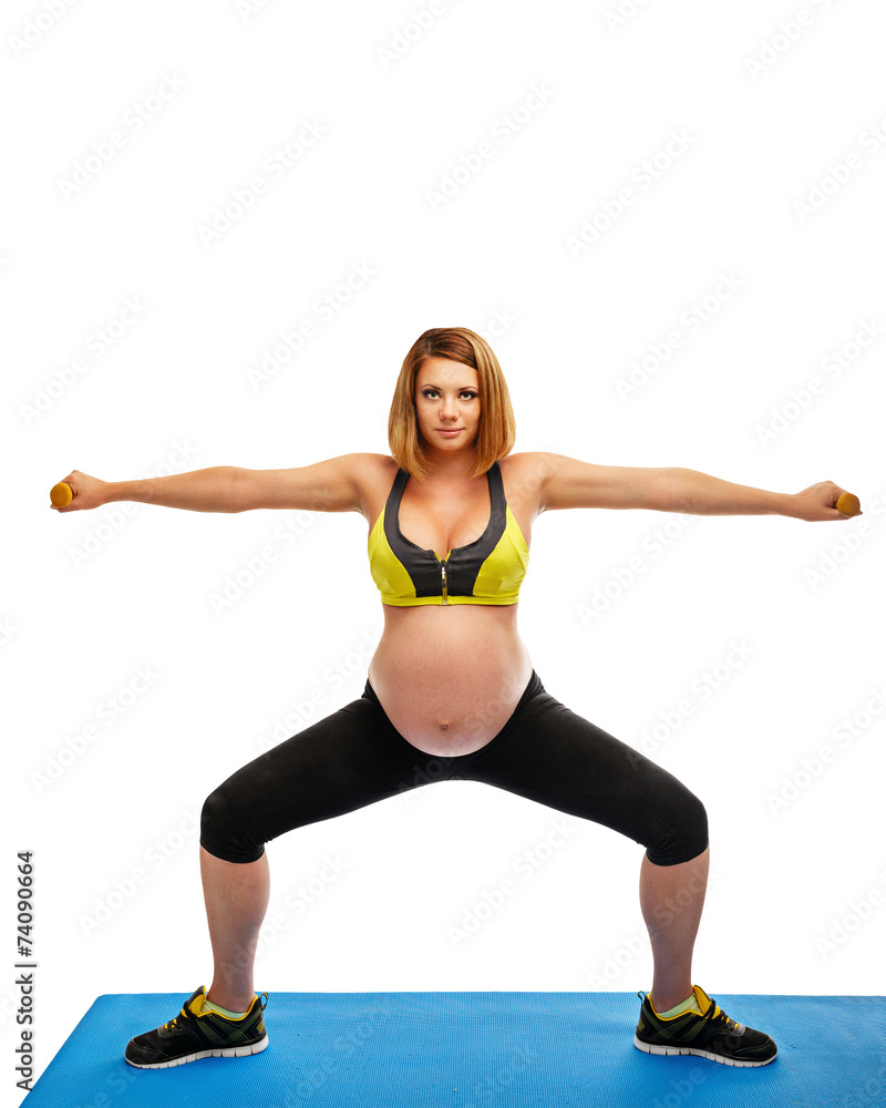 Pregnant woman doing gymnastic exercises Pregnant woman doing gymnastic exercises