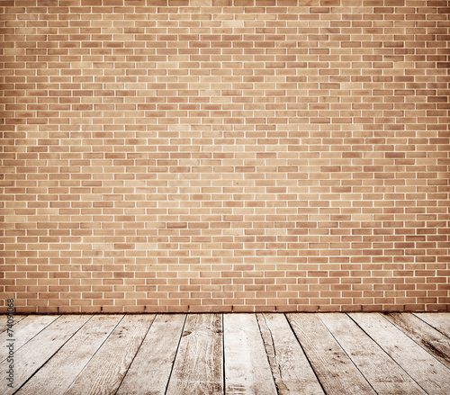 Tall brick wall with wooden floor