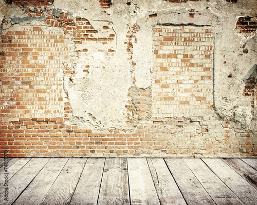 Tall brick wall with wooden floor