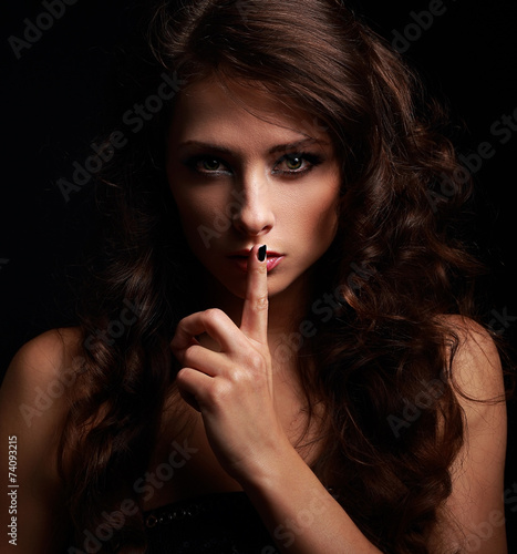 Long hair girl showing secret sign and looking. Closeup portrait