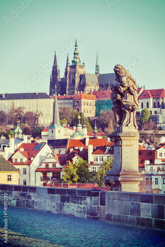 Statue on Charles Brigde against St. Vitus Cathedral in Prague © Dmitry Rukhlenko
