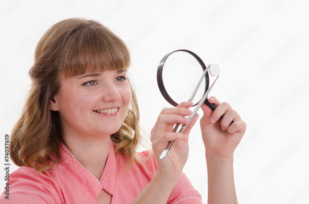 Pharmacist closely examines tablet under a magnifying glass Pharmacist closely examines tablet under a magnifying glass