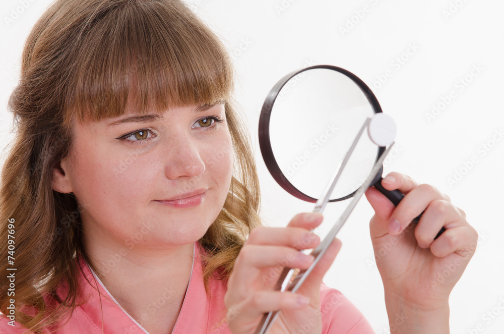 pharmacist is considering a tablet under magnifying glass pharmacist is considering a tablet under magnifying glass
