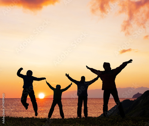 Silhouette of sport friends on beach