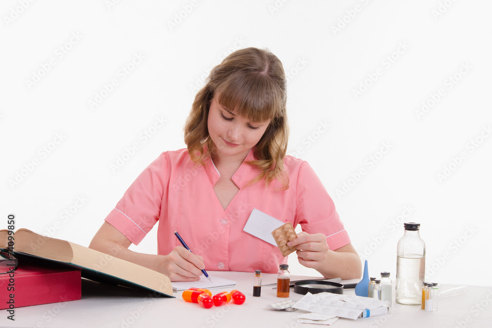 Pharmacist rewrites name tablets to notebook Pharmacist rewrites name tablets to notebook