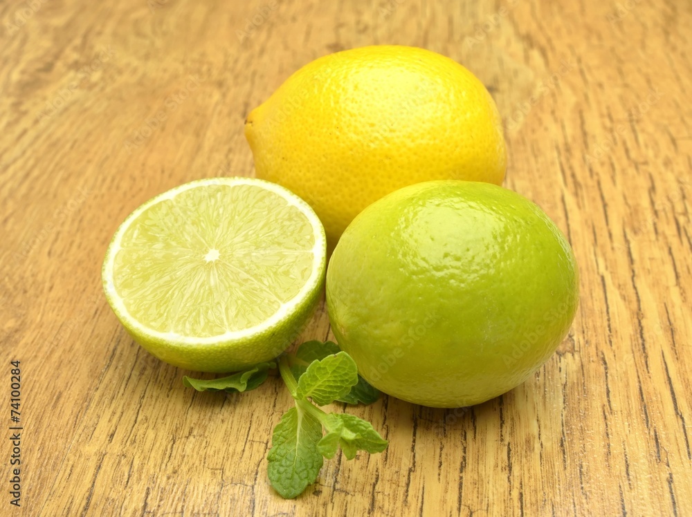 Fresh lime and lemon on wooden background Fresh lime and lemon on wooden background