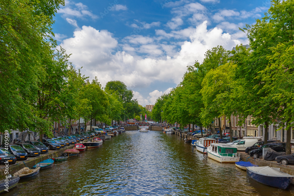 City view of Amsterdam canal with boats, Holland, Netherlands.