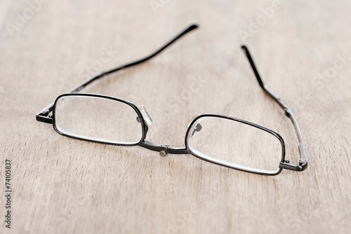 Small reading glasses on a table top