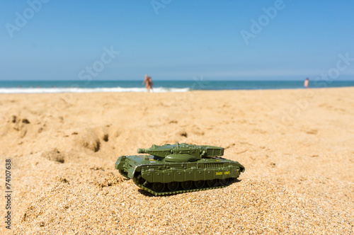 Toy tank at a sunny beach
