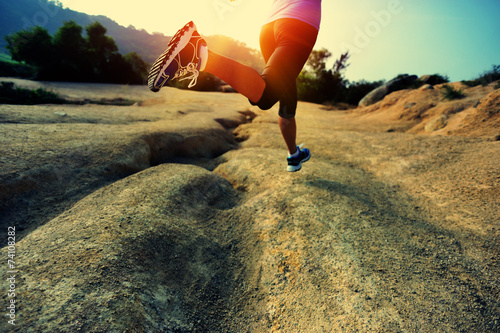 fitness woman legs running on desert trail © lzf