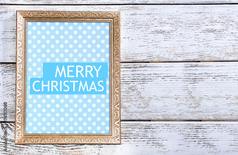 Fototapeta premium Christmas greeting card with frame on wooden background