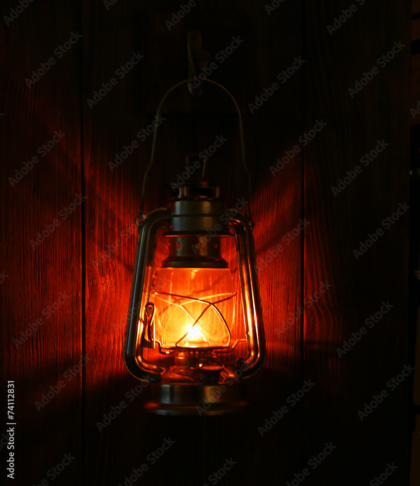Lantern hanging on hook on wooden wall - obrazy, fototapety, plakaty 