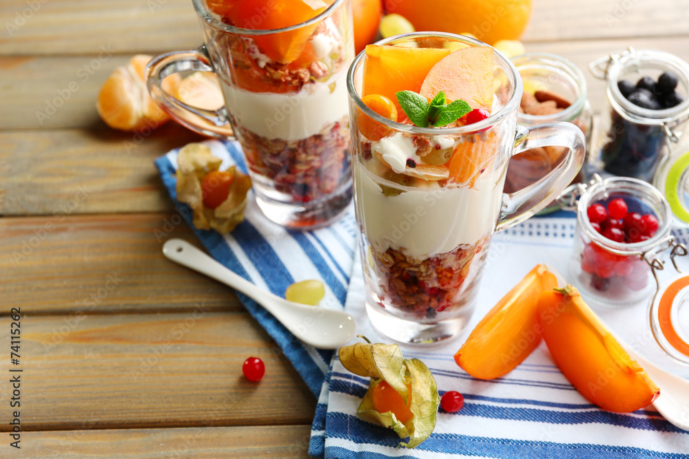 Healthy layered dessert with muesli and fruits on table Healthy layered dessert with muesli and fruits on table