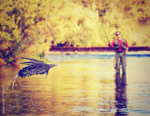 Fotografie, Tablou a person fly fishing with a big trout in front