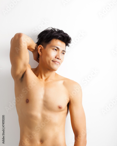 smiling shirtless muscular young asian man