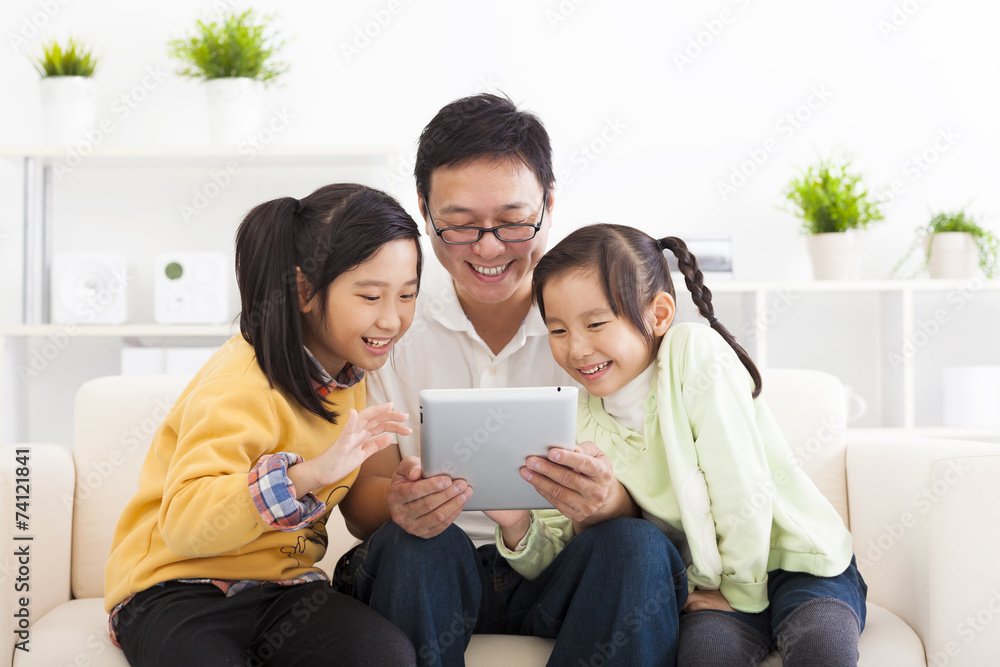 happy father using tablet pc with little girls happy father using tablet pc with little girls