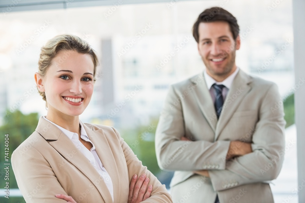 Business people posing with arms crossed smiling at camera Business people posing with arms crossed smiling at camera