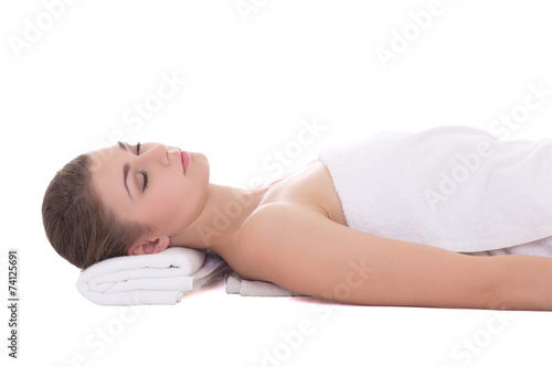 young beautiful woman relaxing on a massage table isolated on wh