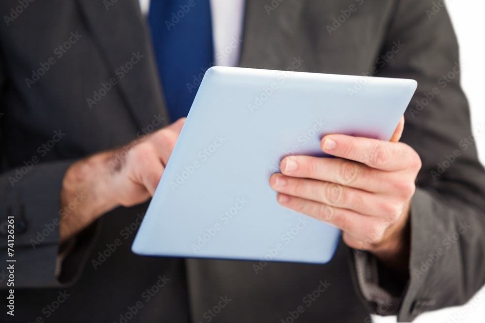 Businessman scrolling on his digital tablet Businessman scrolling on his digital tablet