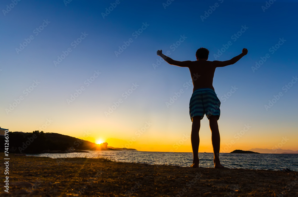 Silhouette of a Man with on a beach, freedom Concept