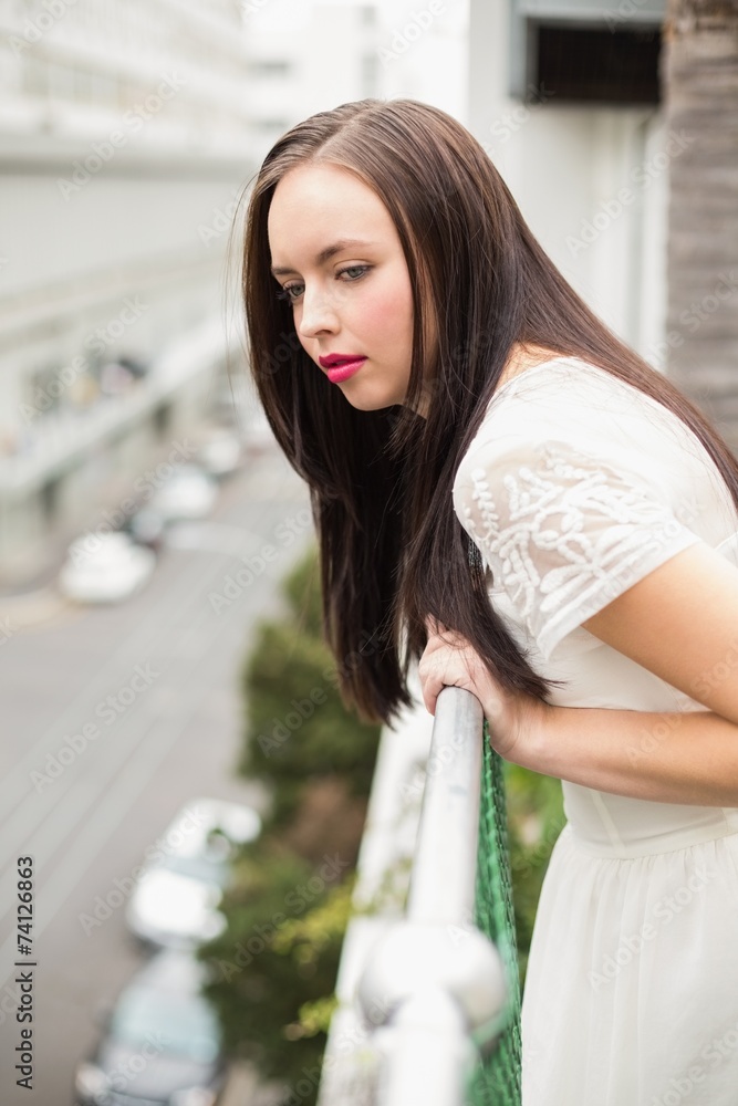Pretty brunette looking over the balcony Pretty brunette looking over the balcony