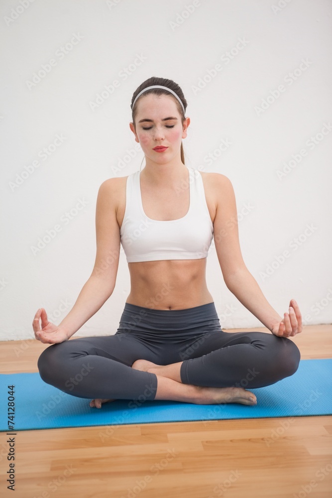 Fototapeta premium Fit brunette doing yoga at home
