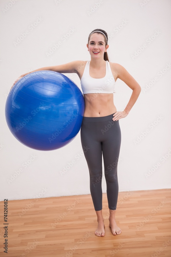 Fit brunette holding exercise ball Fit brunette holding exercise ball