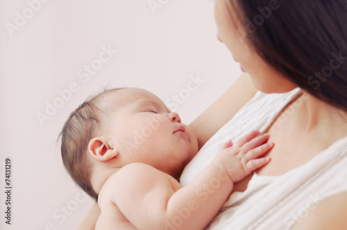 soft image of newborn baby with mother
