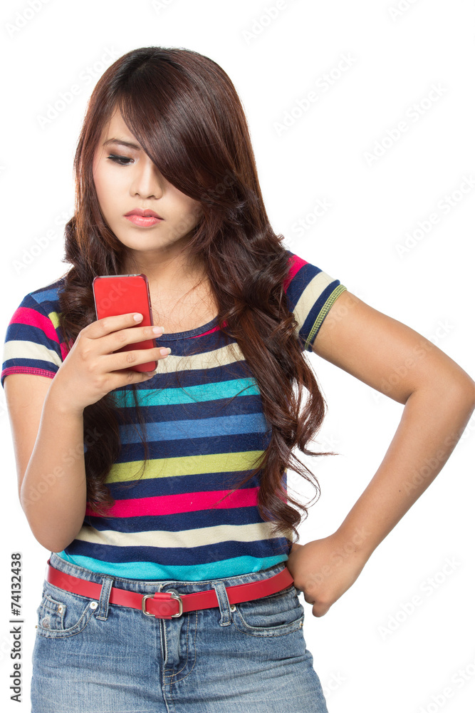 young girl typing on her cellphone young girl typing on her cellphone
