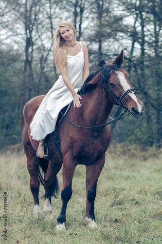 romantic sensual girl in white dress on a horse in the forest © ruslimonchyk