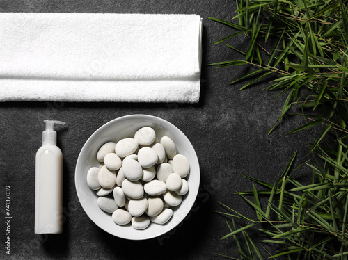 Bamboo leaves and a white towel for massage