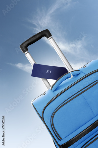 EU. Blue suitcase with label