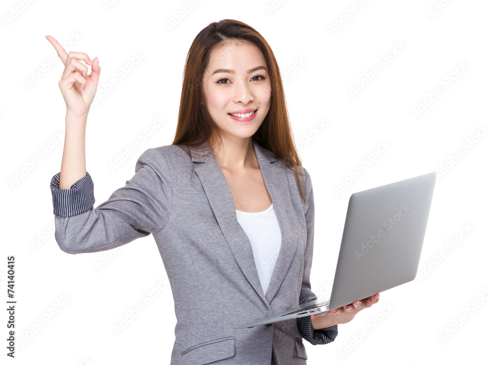 Businesswoman use of laptop and finger point up Businesswoman use of laptop and finger point up