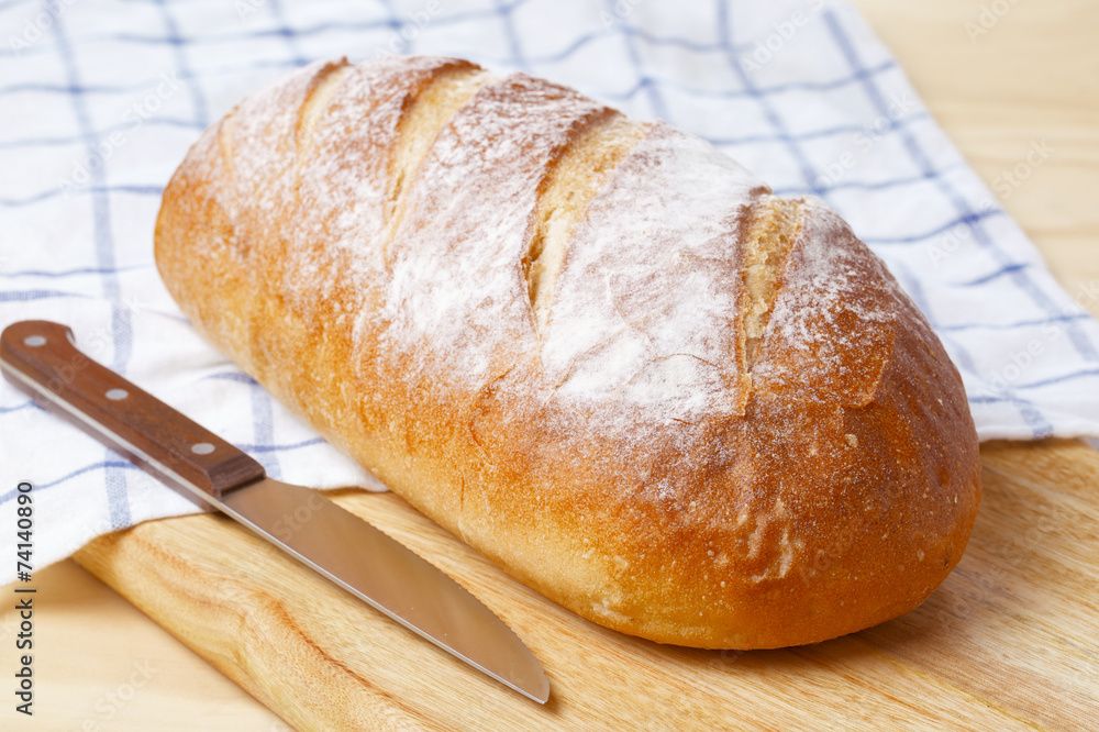 White bread loaf on wooden table White bread loaf on wooden table