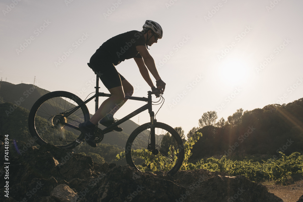 Naklejka premium The young man cycling Cross-country