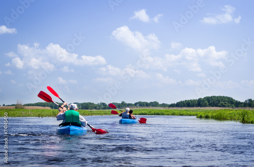 Elderly couples kayaking on Biebrza river