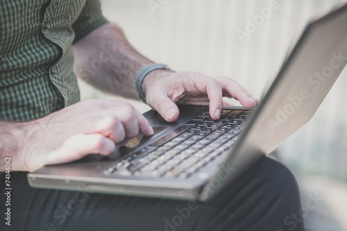 close up of man hands using laptop
