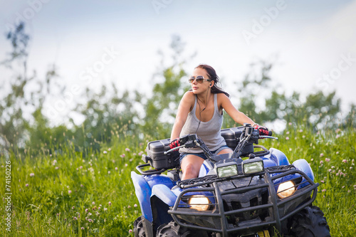 Elegant woman riding extreme quadrocycle