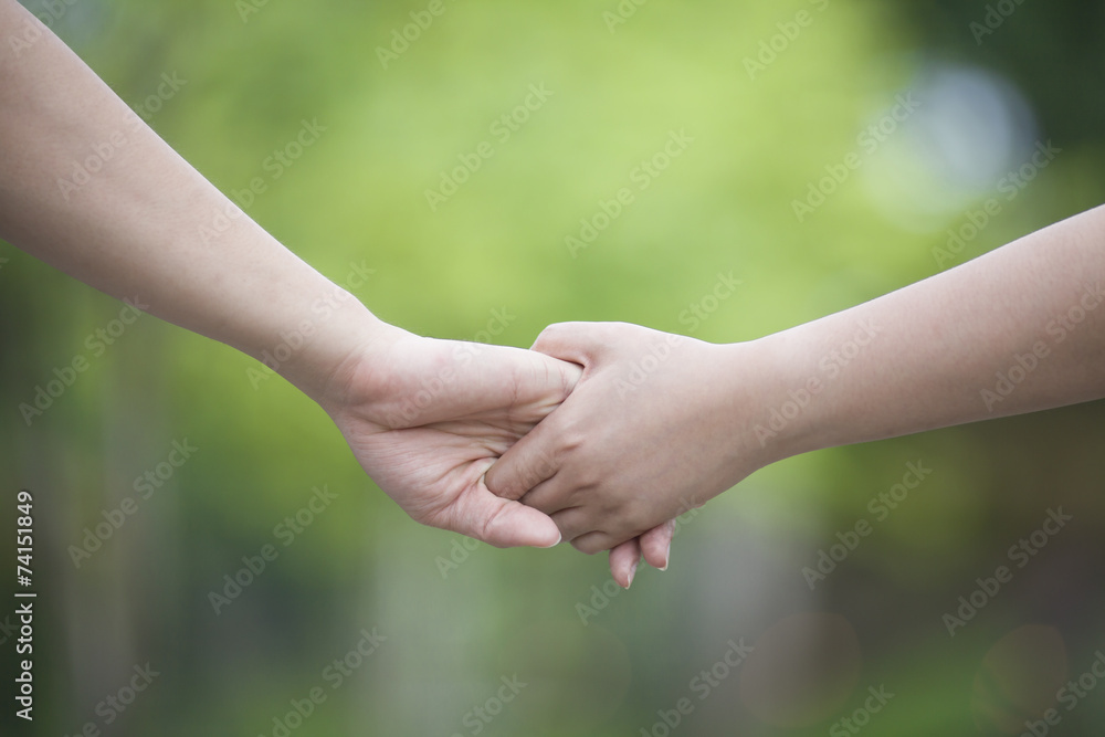 Lovers couple holding hands in a forest Lovers couple holding hands in a forest