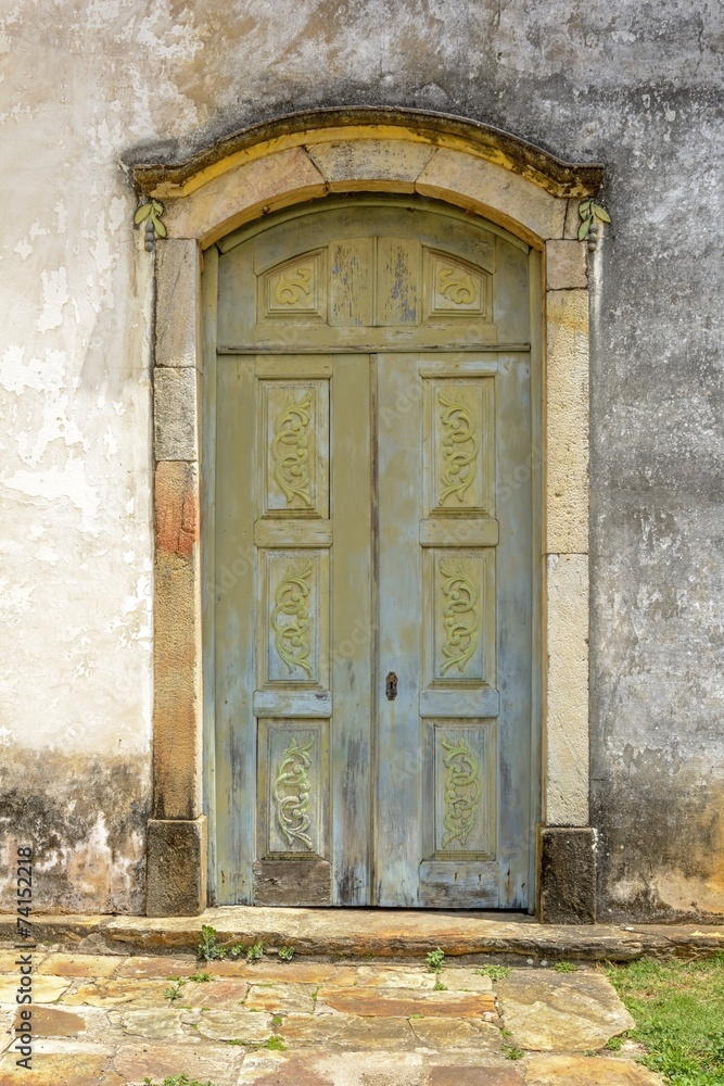 Old carved wooden church door in the city of Ouro Preto Old carved wooden church door in the city of Ouro Preto