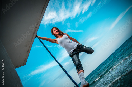 Wallpaper Mural Young woman standing and looking on the beach Torontodigital.ca