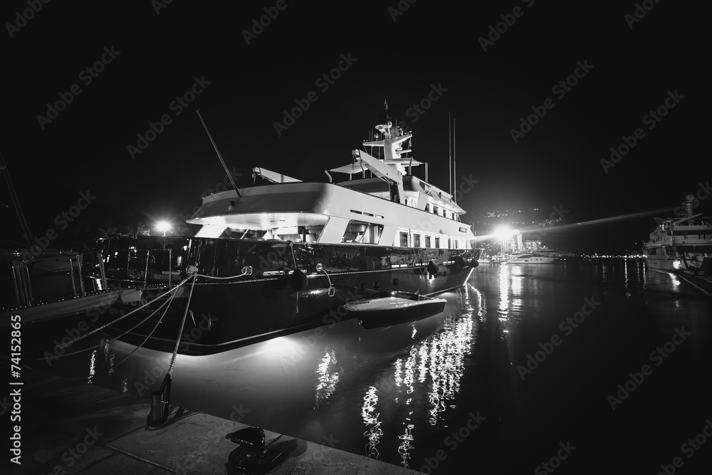 Monochrome photo of luxurious private yacht moored at pier at ni